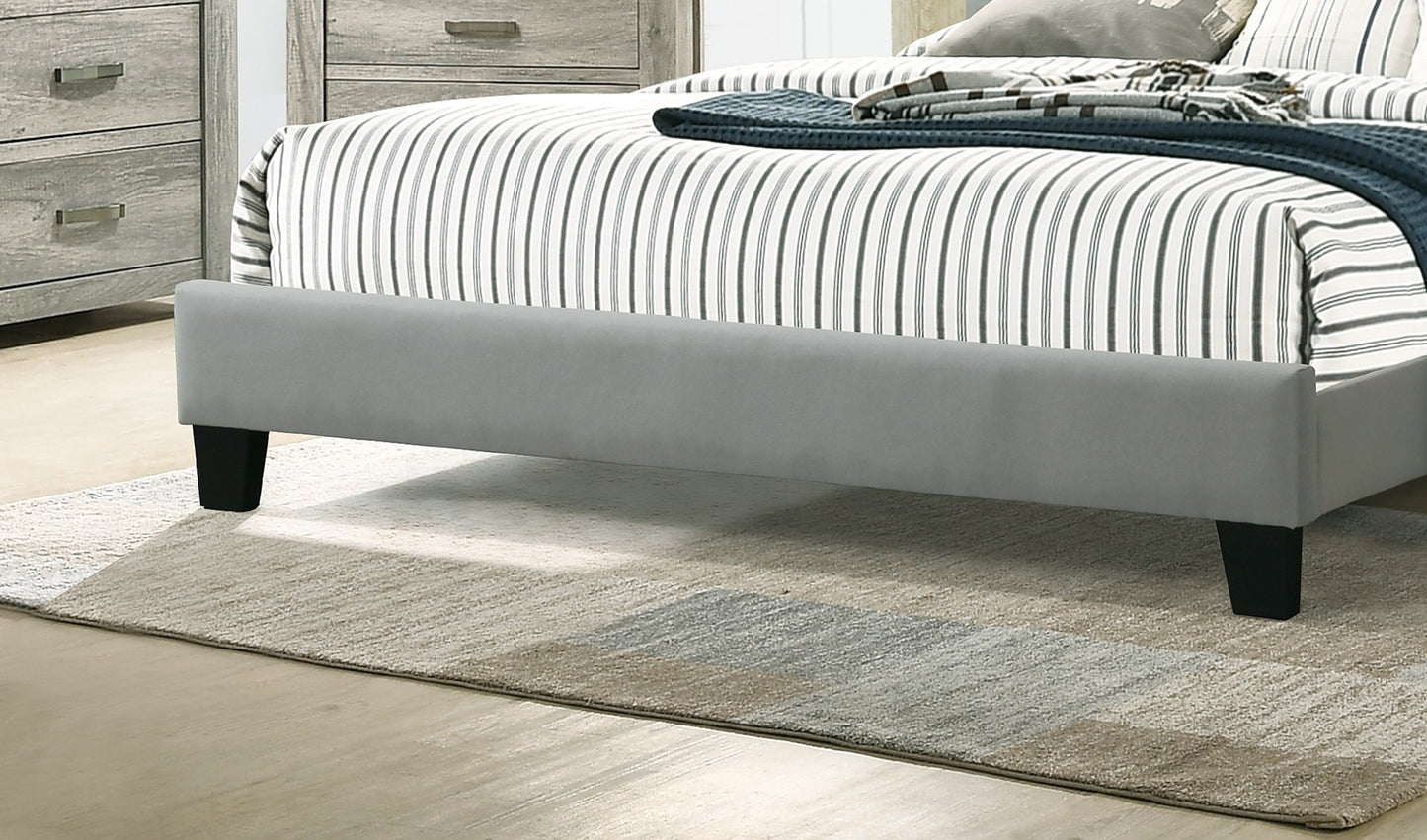 Gray upholstered queen bed frame with black legs and striped bedding