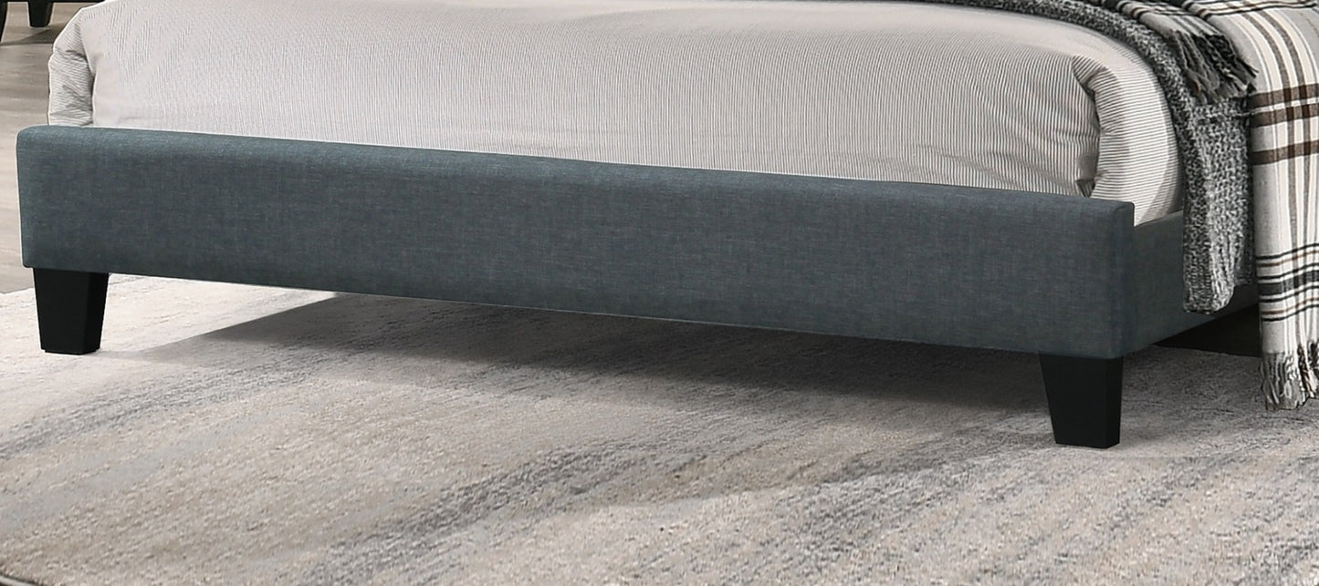 Modern grey upholstered bed frame with black legs and striped bedding
