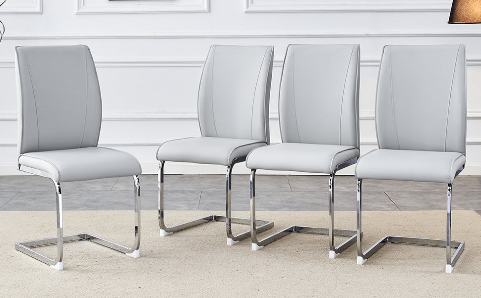 Four modern grey faux leather dining chairs with chrome cantilever legs
