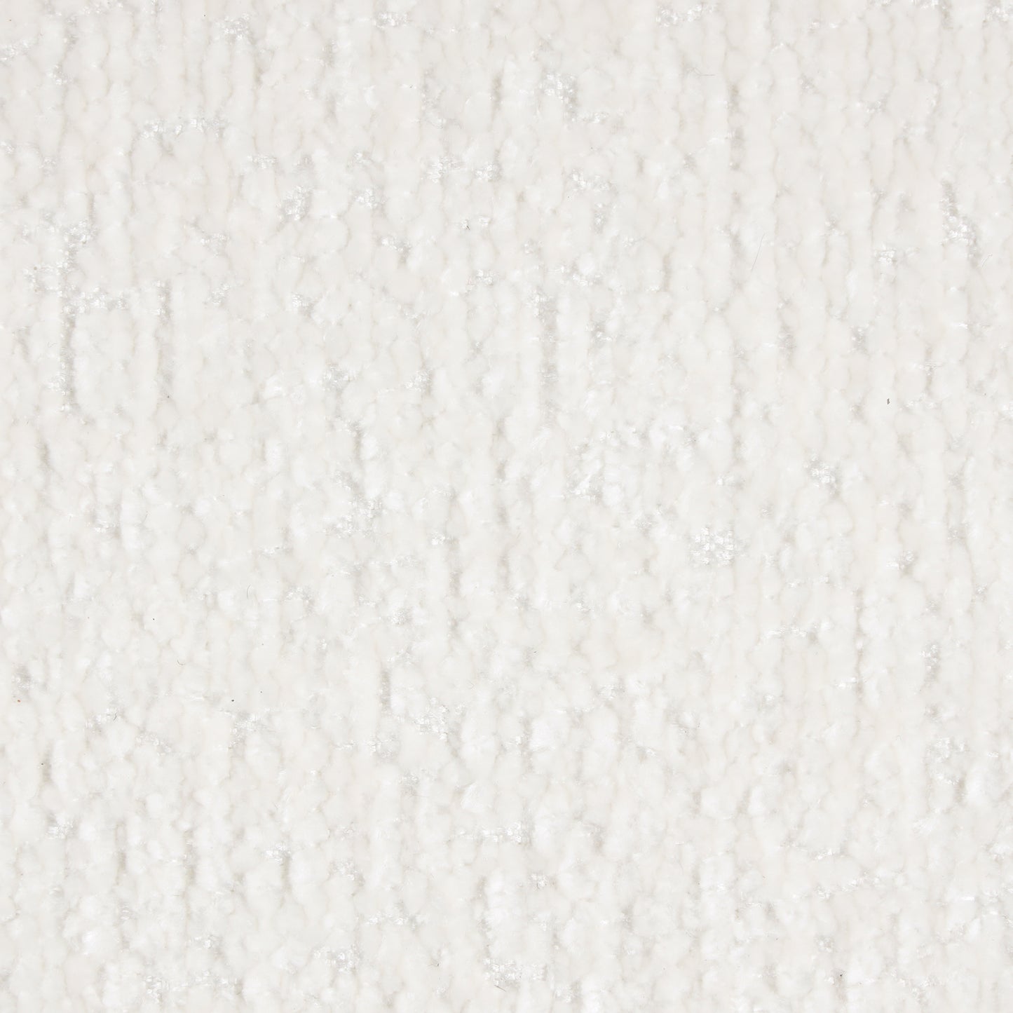 Closeup of a textured white fabric with raised irregular bumps and a slight shimmer