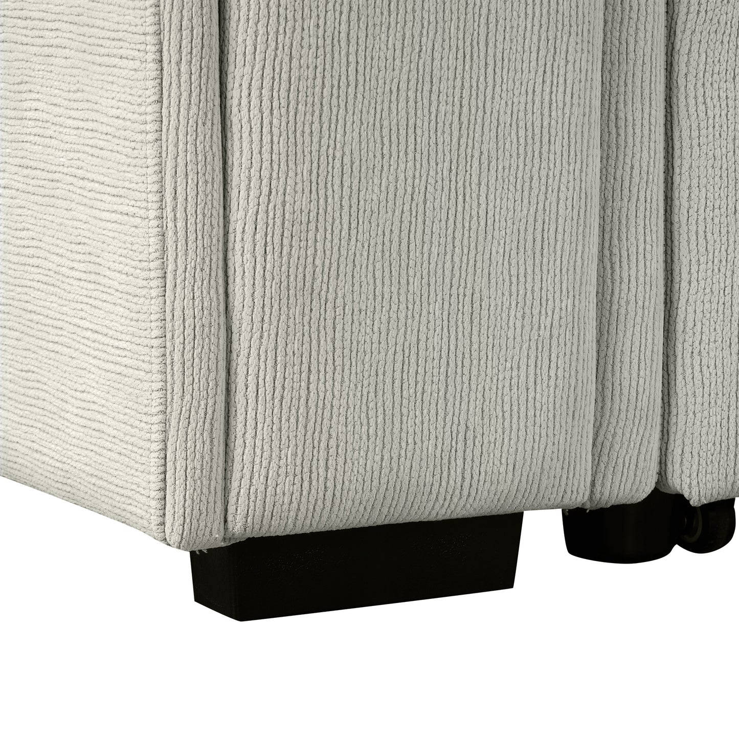 Closeup of textured light gray fabric on a sofa armrest with black feet