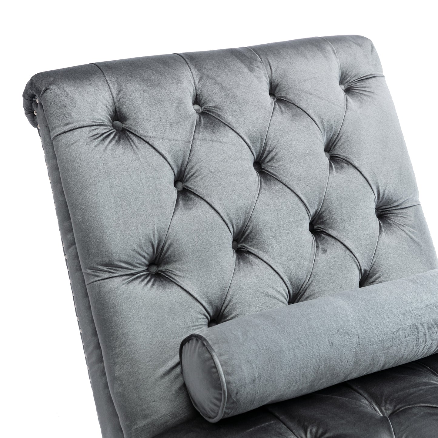 Tufted grey velvet chaise lounge with bolster pillow for luxurious relaxation