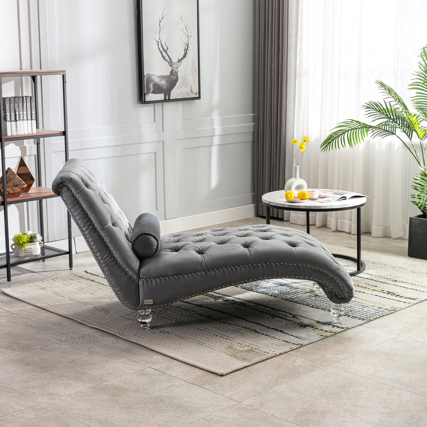 Tufted grey velvet chaise lounge with silver nailhead trim and clear acrylic legs