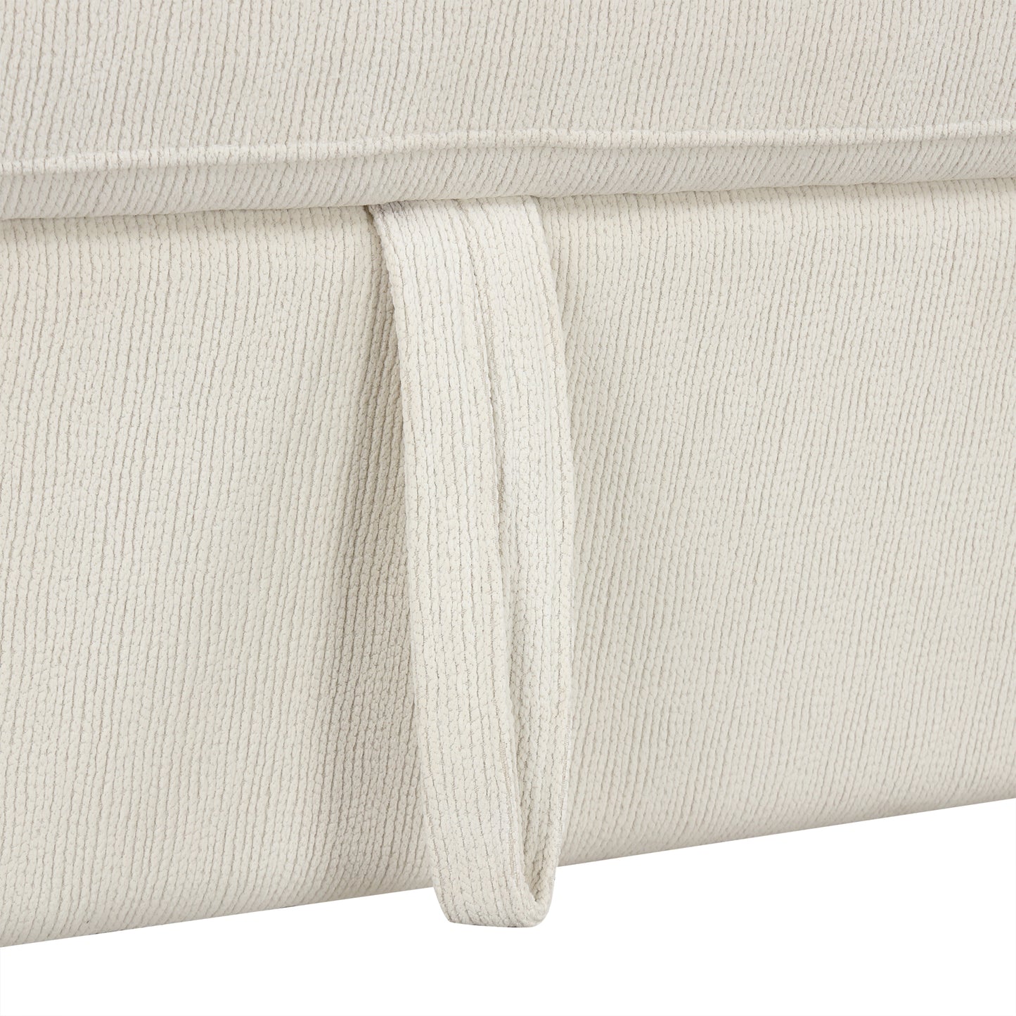 Cream chenille fabric sofa detail with plush texture and a folded fabric strap