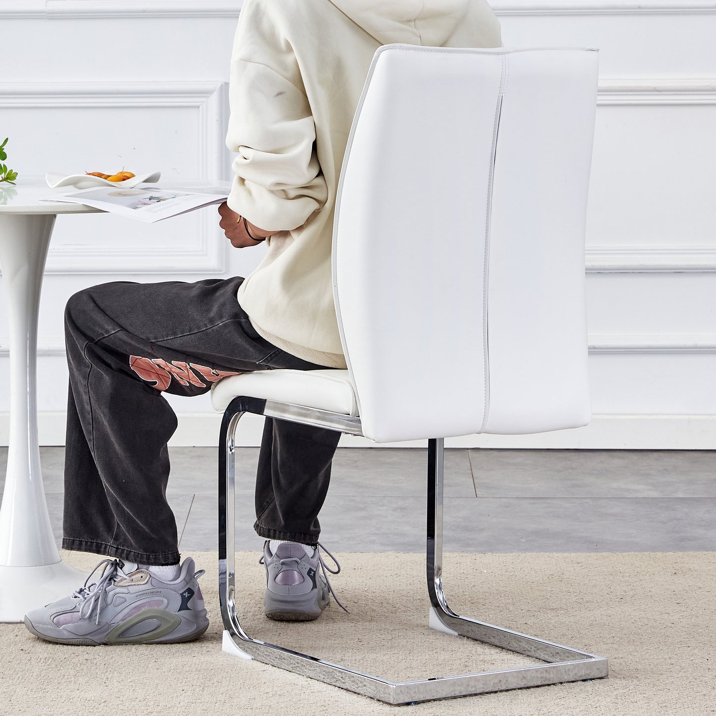 Modern white faux leather dining chair with polished chrome cantilever base