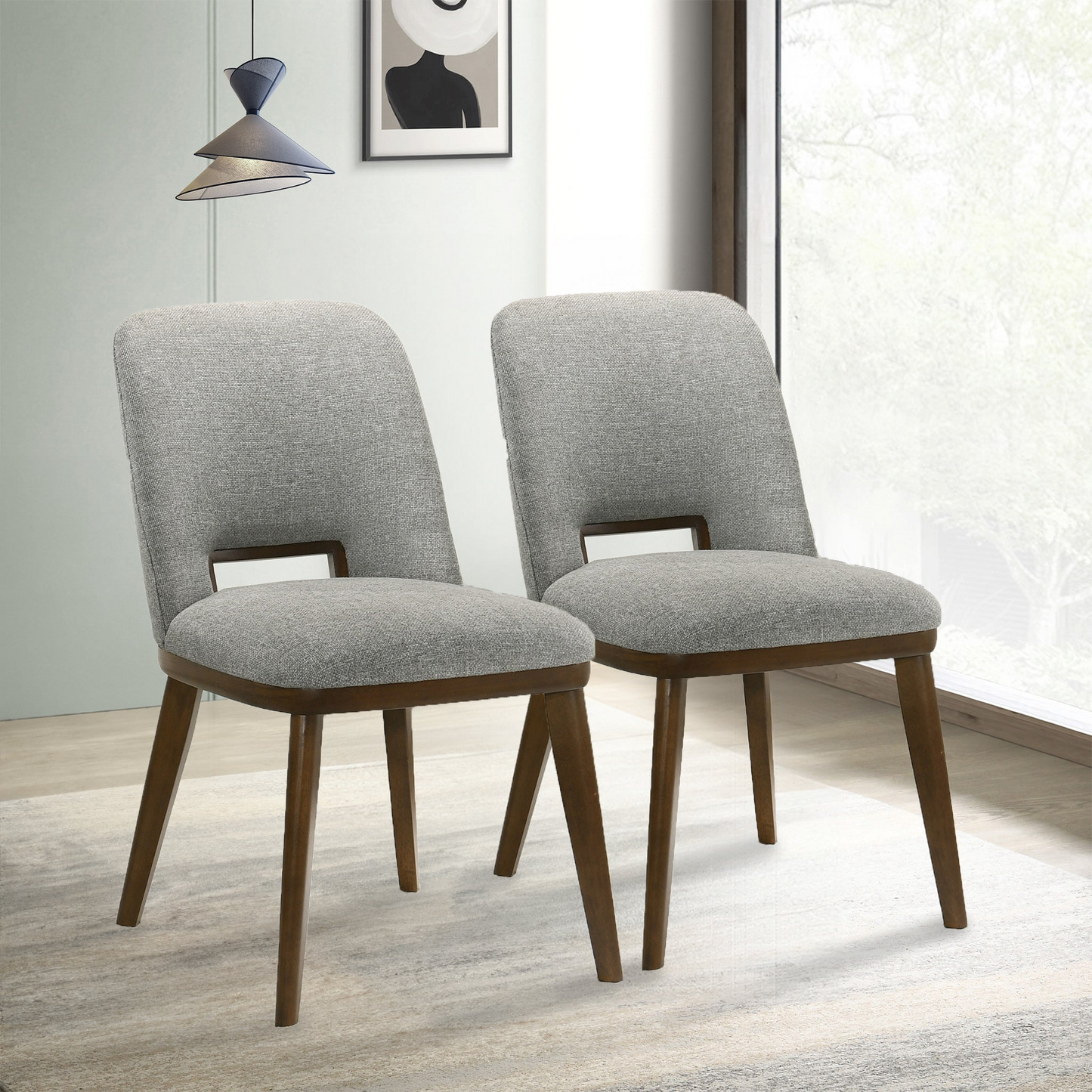 Two grey upholstered dining chairs with dark wood legs