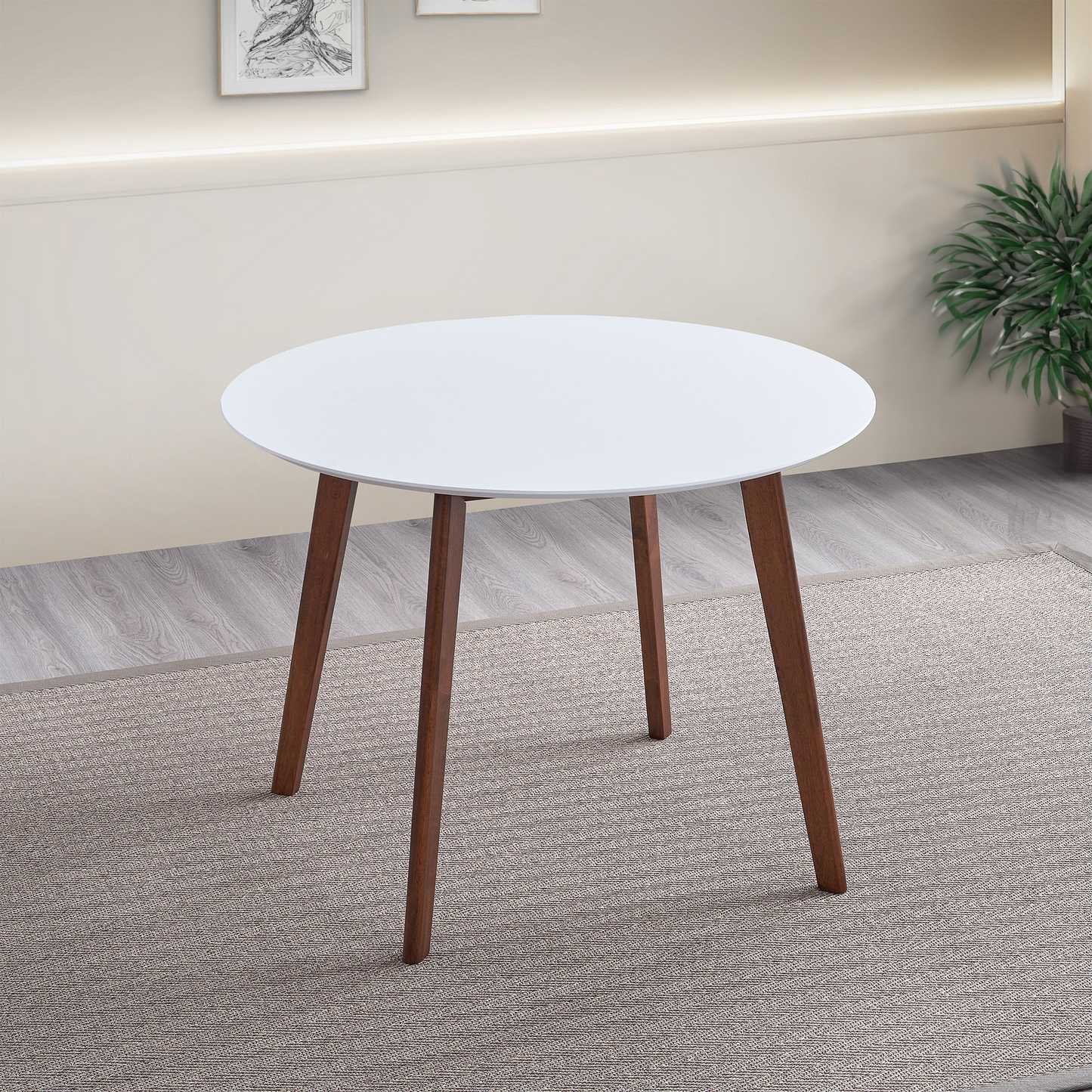 White round dining table with dark wood tapered legs perfect for small spaces