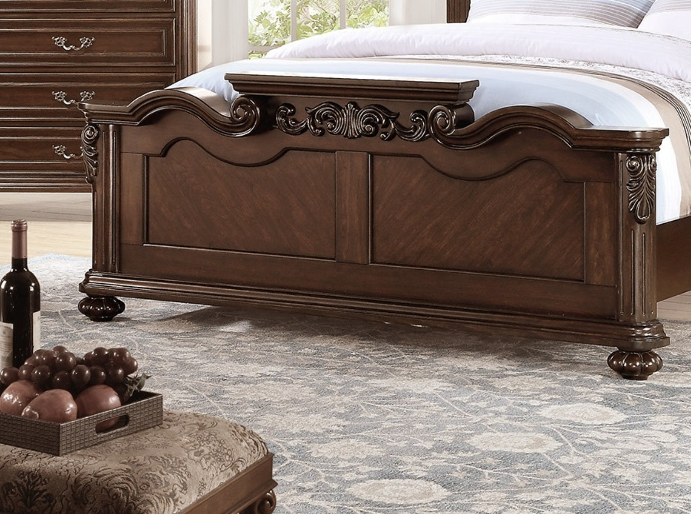 Dark wood ornate carved headboard bed frame with decorative scrollwork and carved legs
