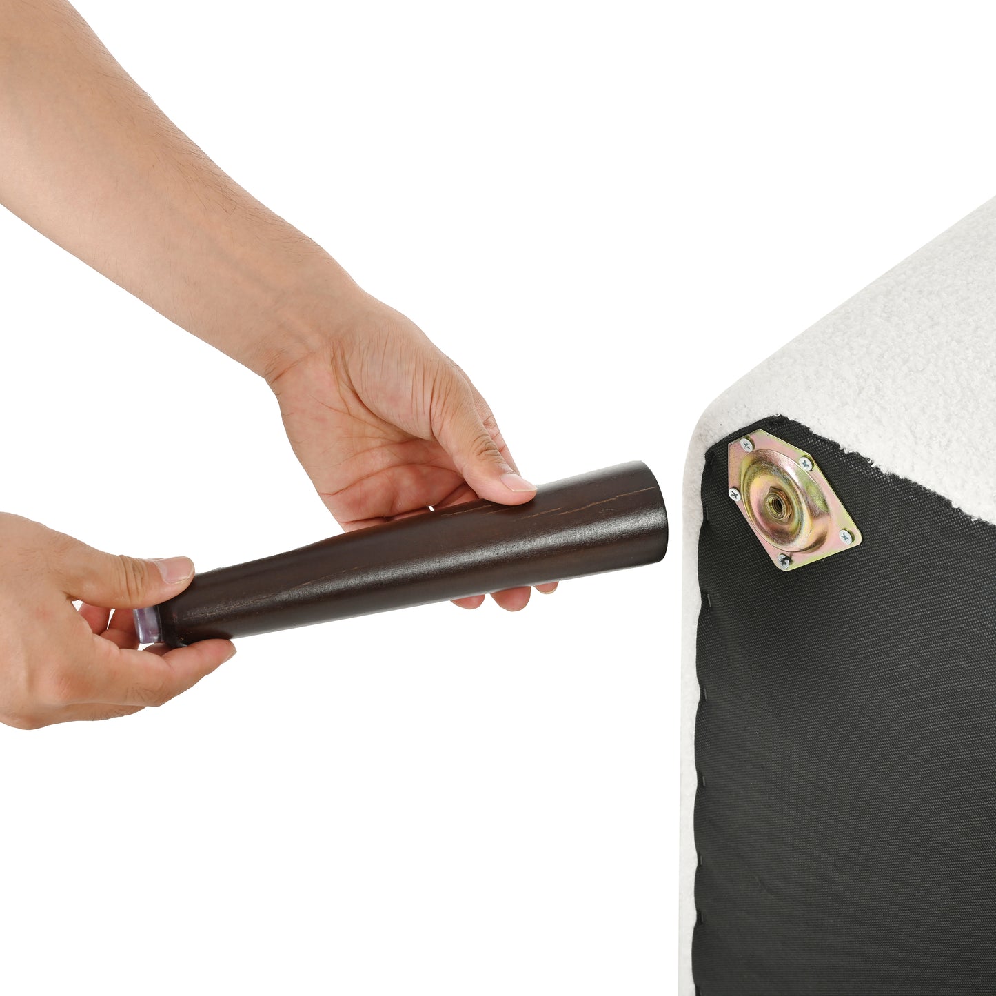 Dark wood furniture leg with protective cap being attached to sofa base