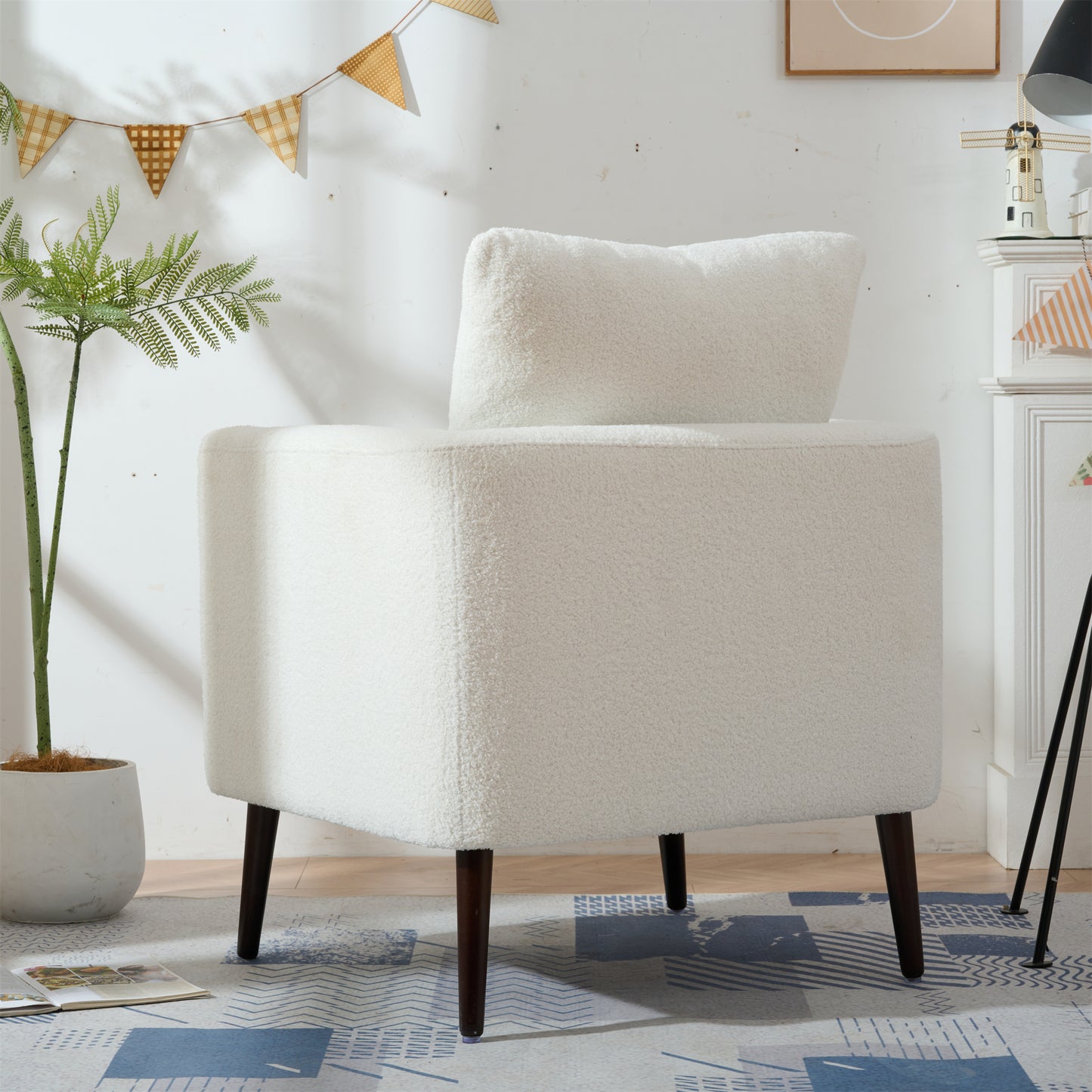 White boucle accent chair with dark wood legs and plush cushion