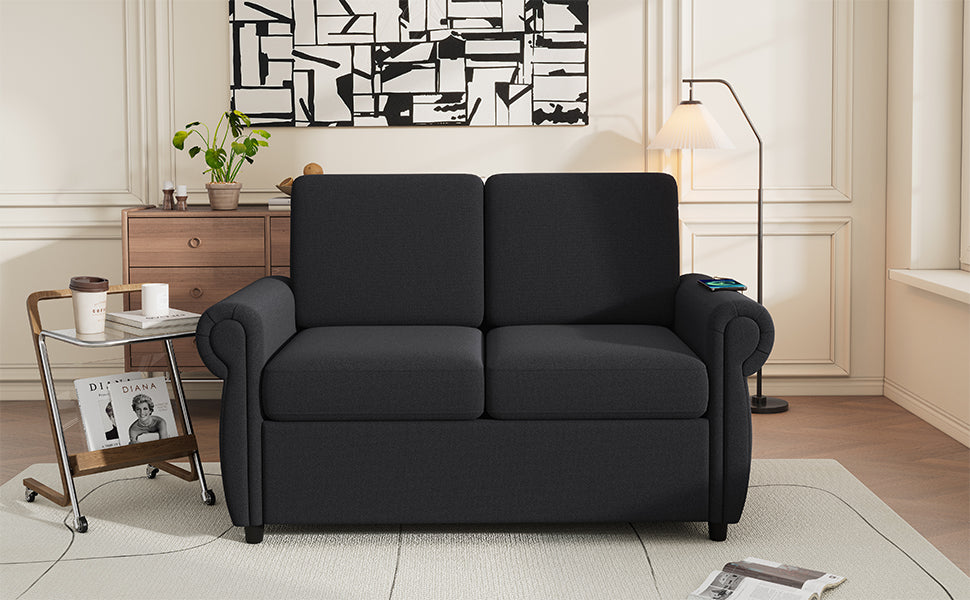 Dark gray upholstered loveseat with rolled arms and plush cushions