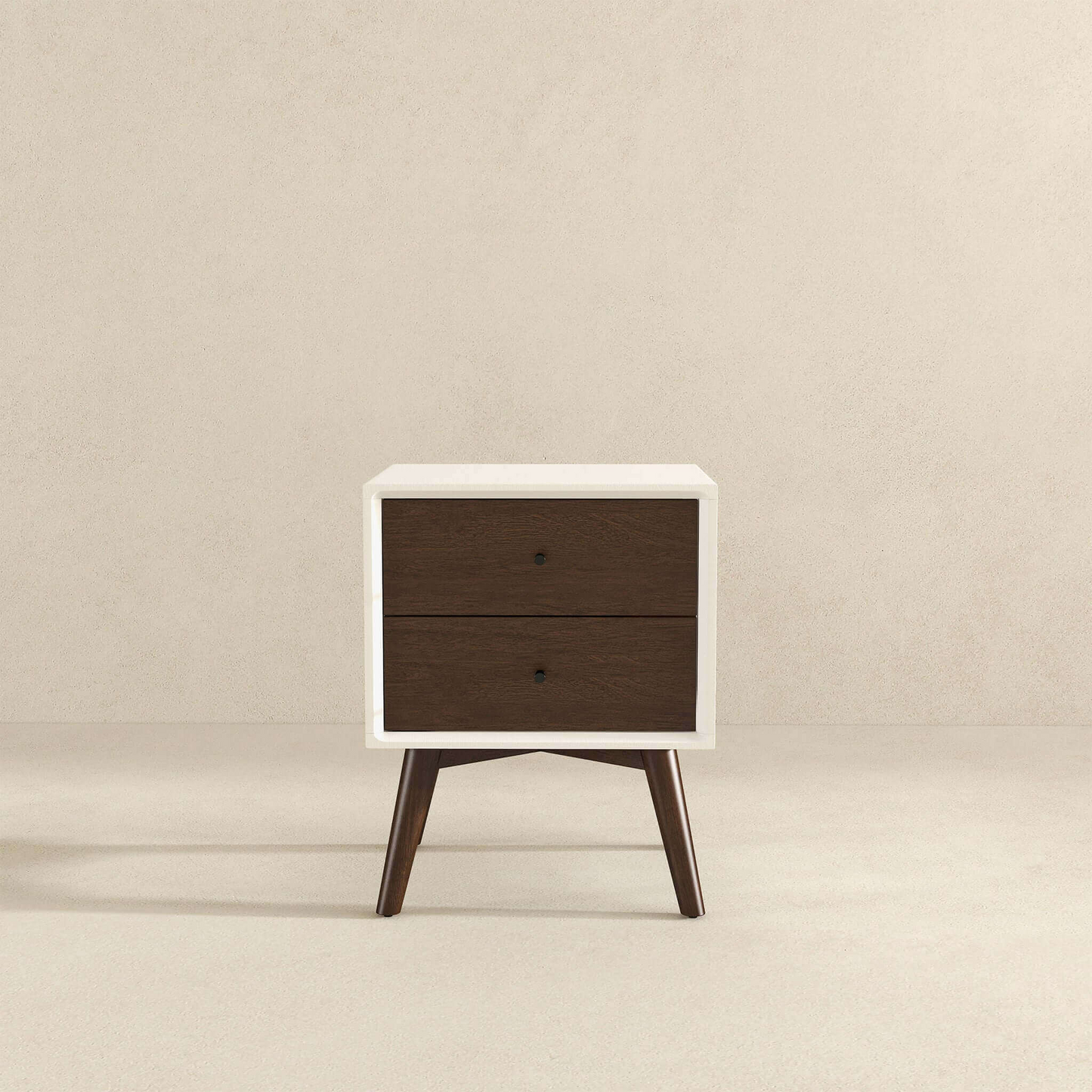 White midcentury modern nightstand with two dark wood drawers and tapered legs