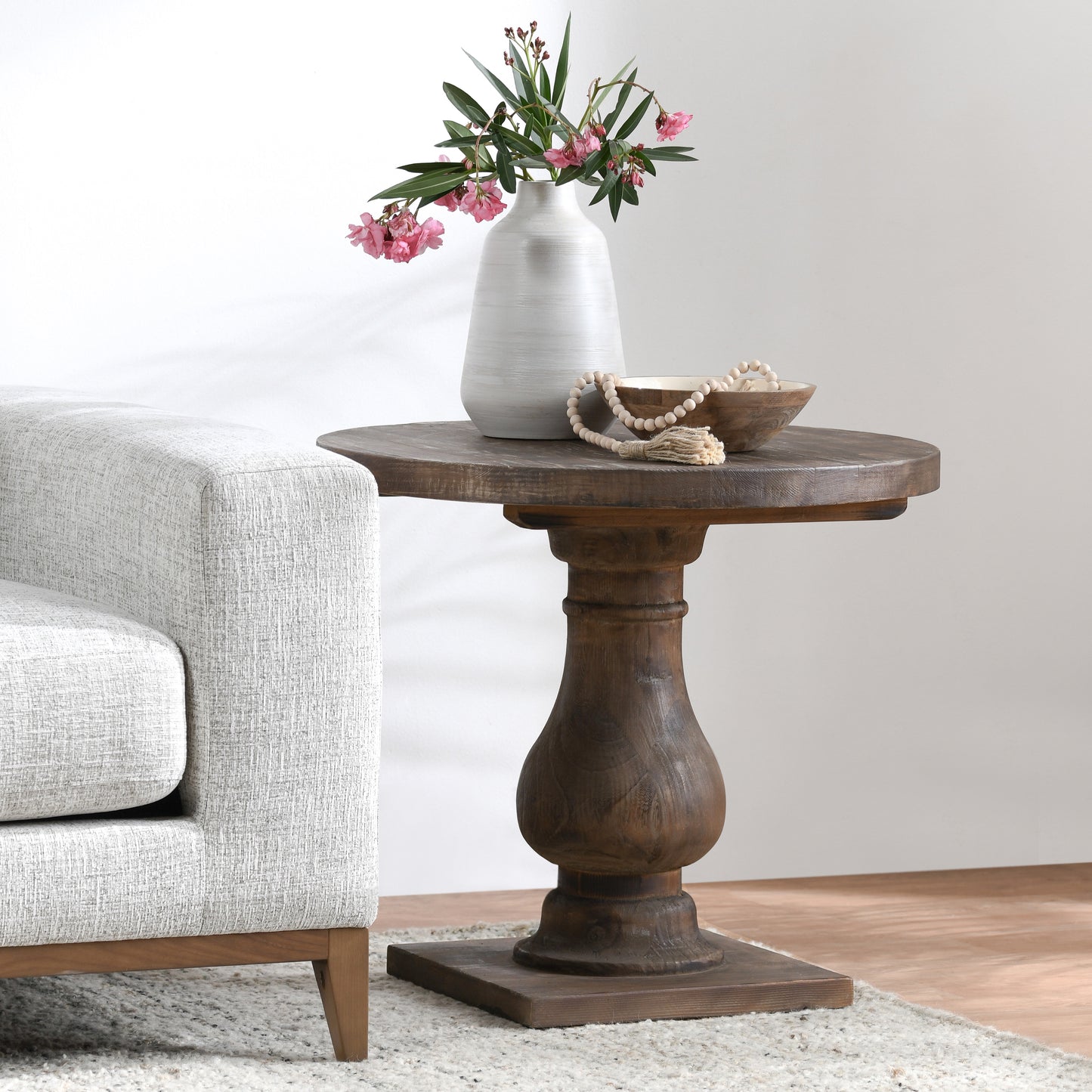 Round reclaimed wood accent table with turned pedestal base