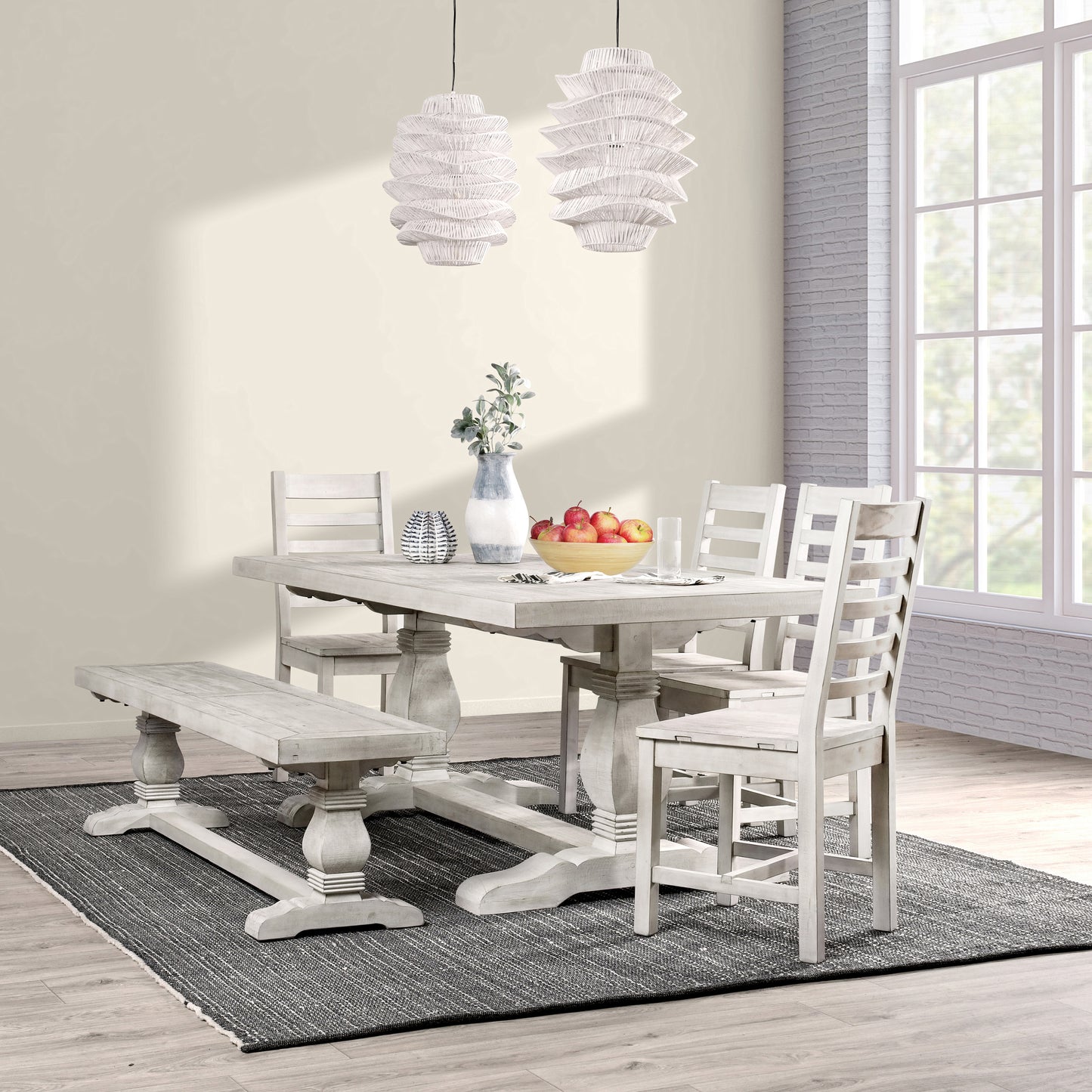 Distressed white farmhouse dining table with matching bench and chairs set for a family meal