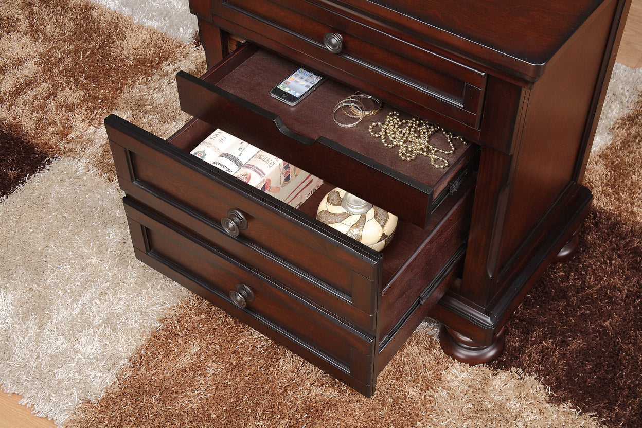 Dark cherry wood nightstand with open drawers showing phone jewelry and decorative items