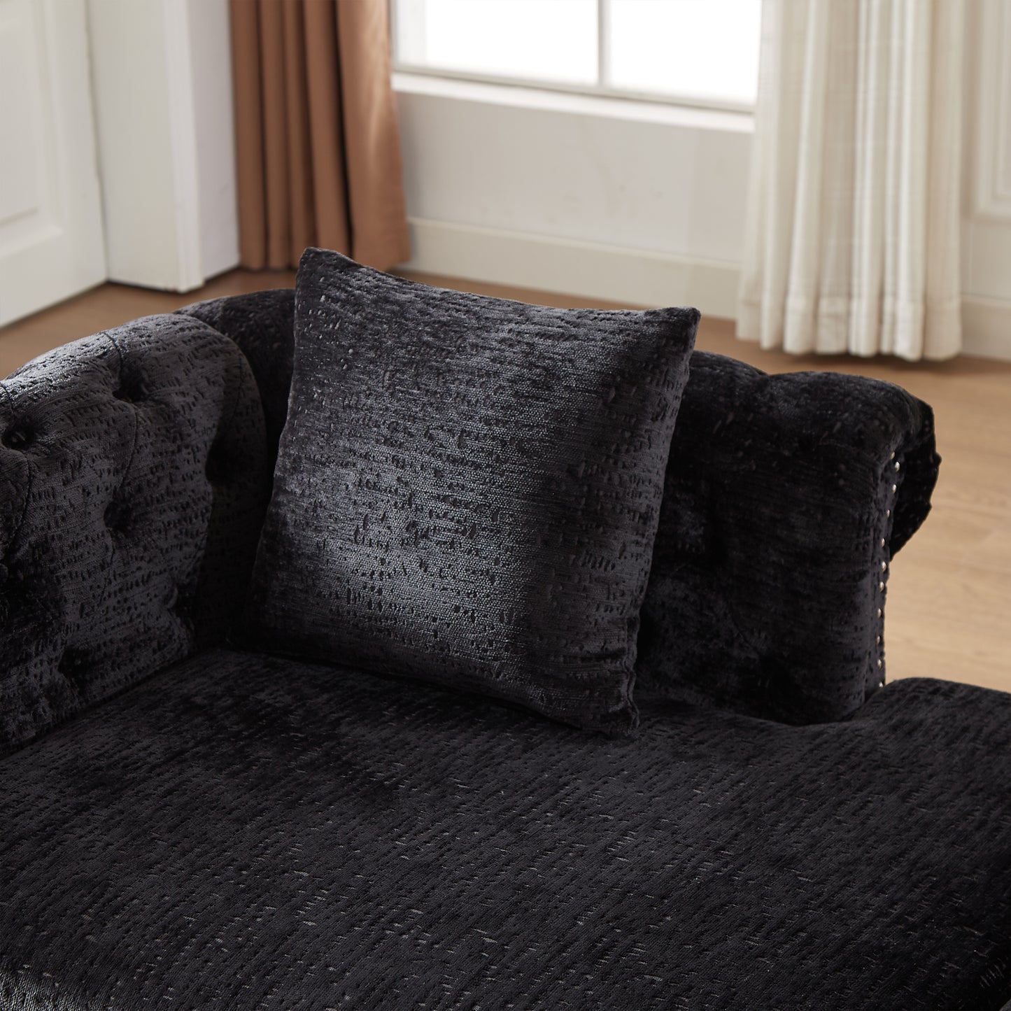 Black velvet tufted armchair with textured throw pillow elegant home decor