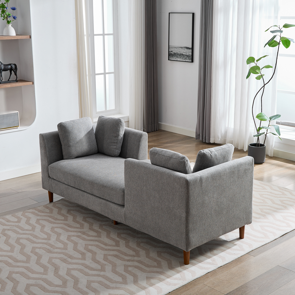 Grey fabric sofa with wooden legs and plush throw pillows perfect for modern living rooms