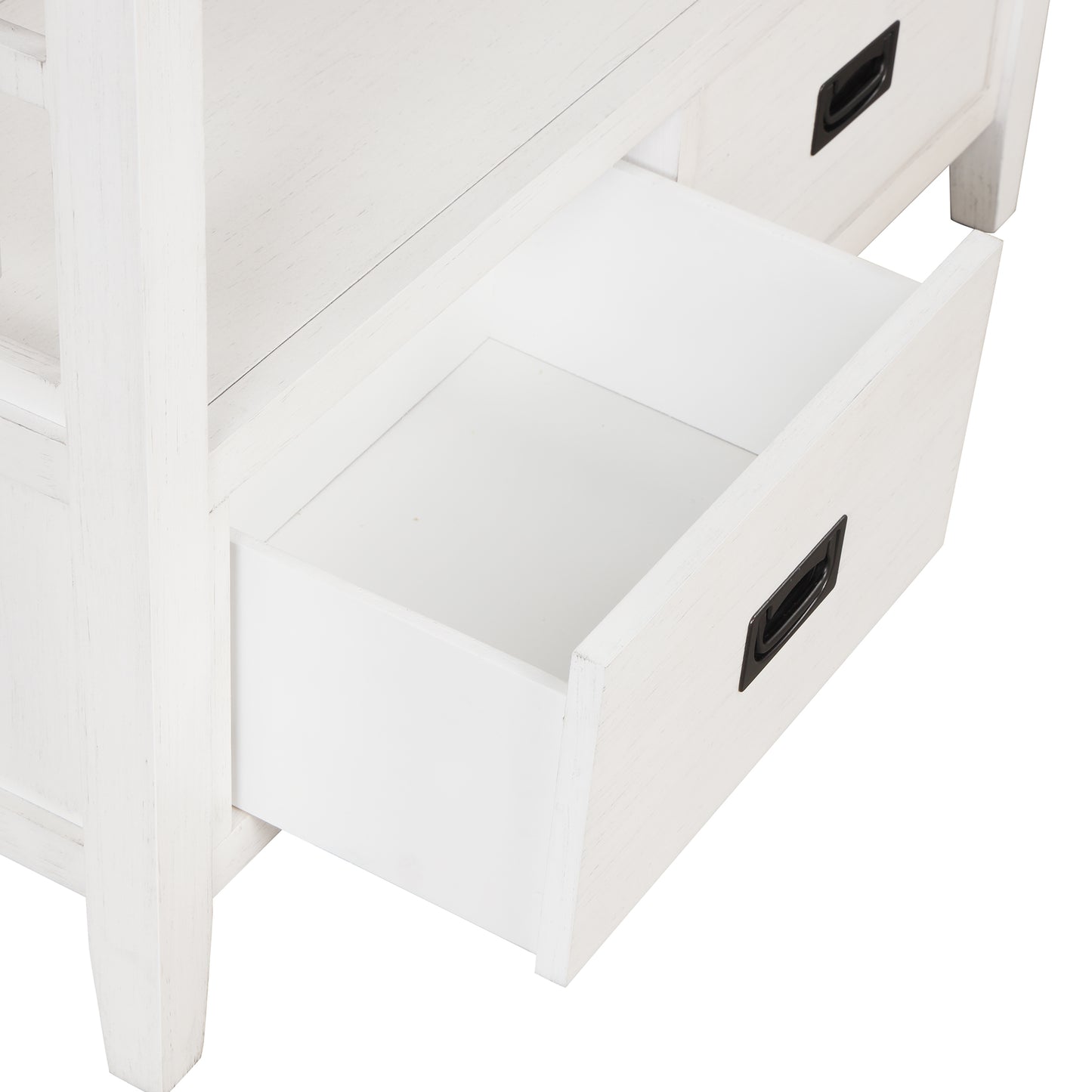 Closeup of an open white wood drawer with a black handle on a rustic side table