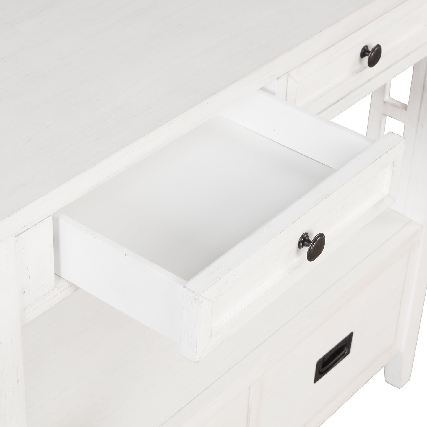Closeup of a white distressed wood desk with an open drawer and antique bronze knobs