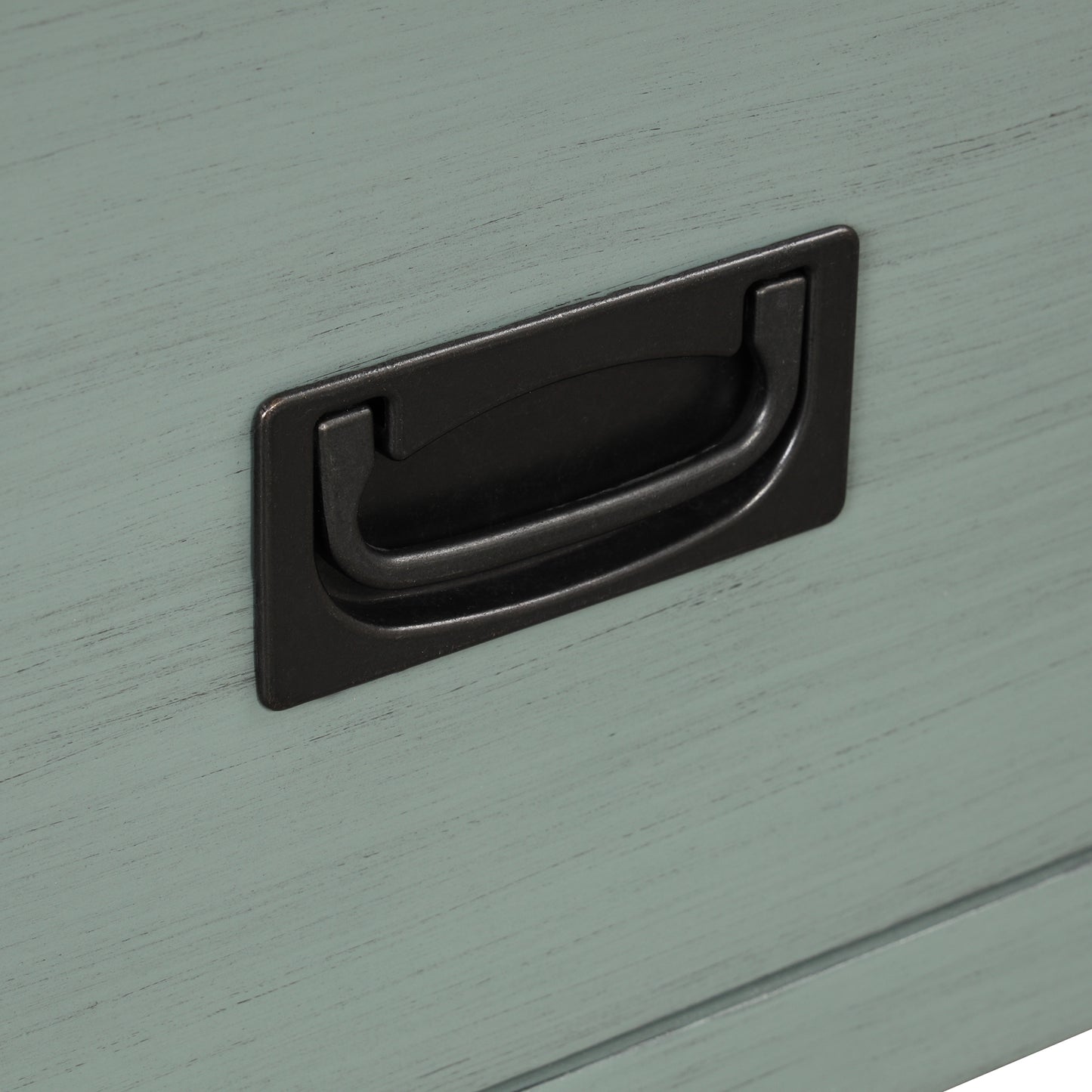 Closeup of distressed blue drawer front with a black metal bail pull handle