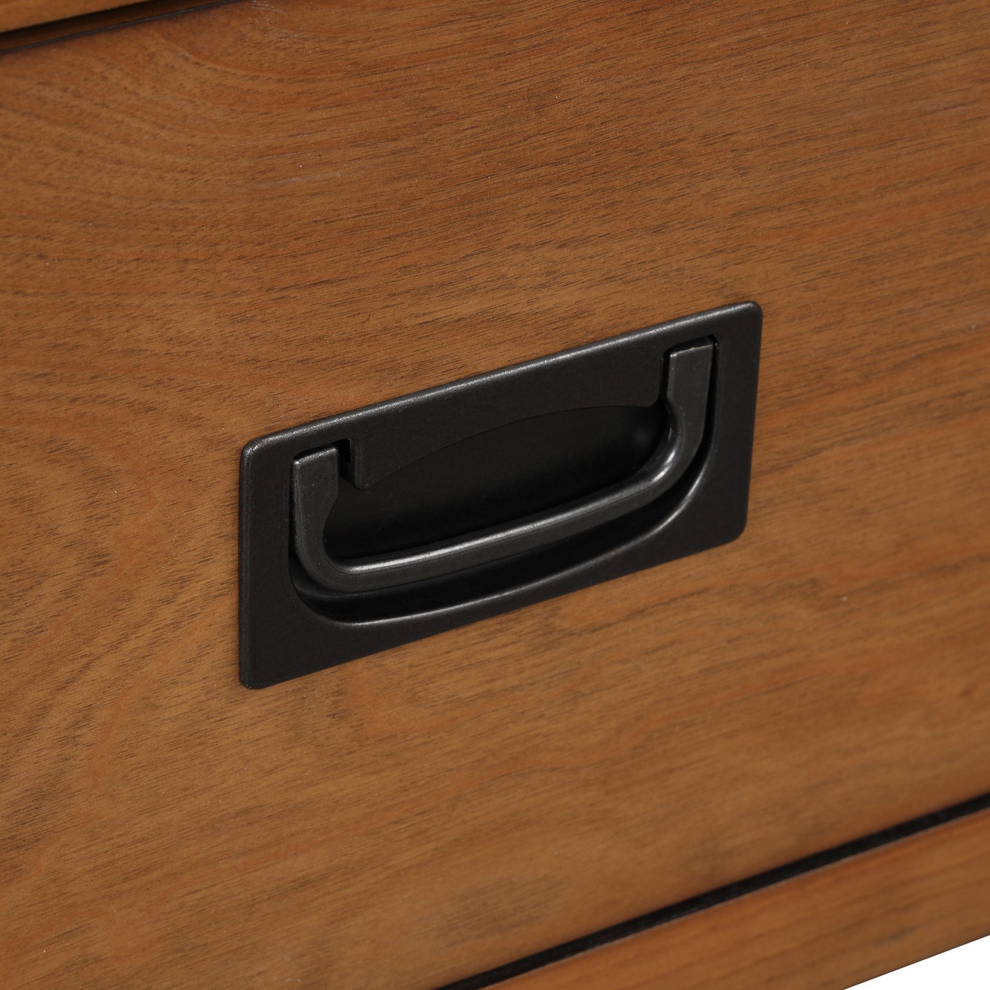 Drawer pull on a rich brown wood surface industrial style hardware