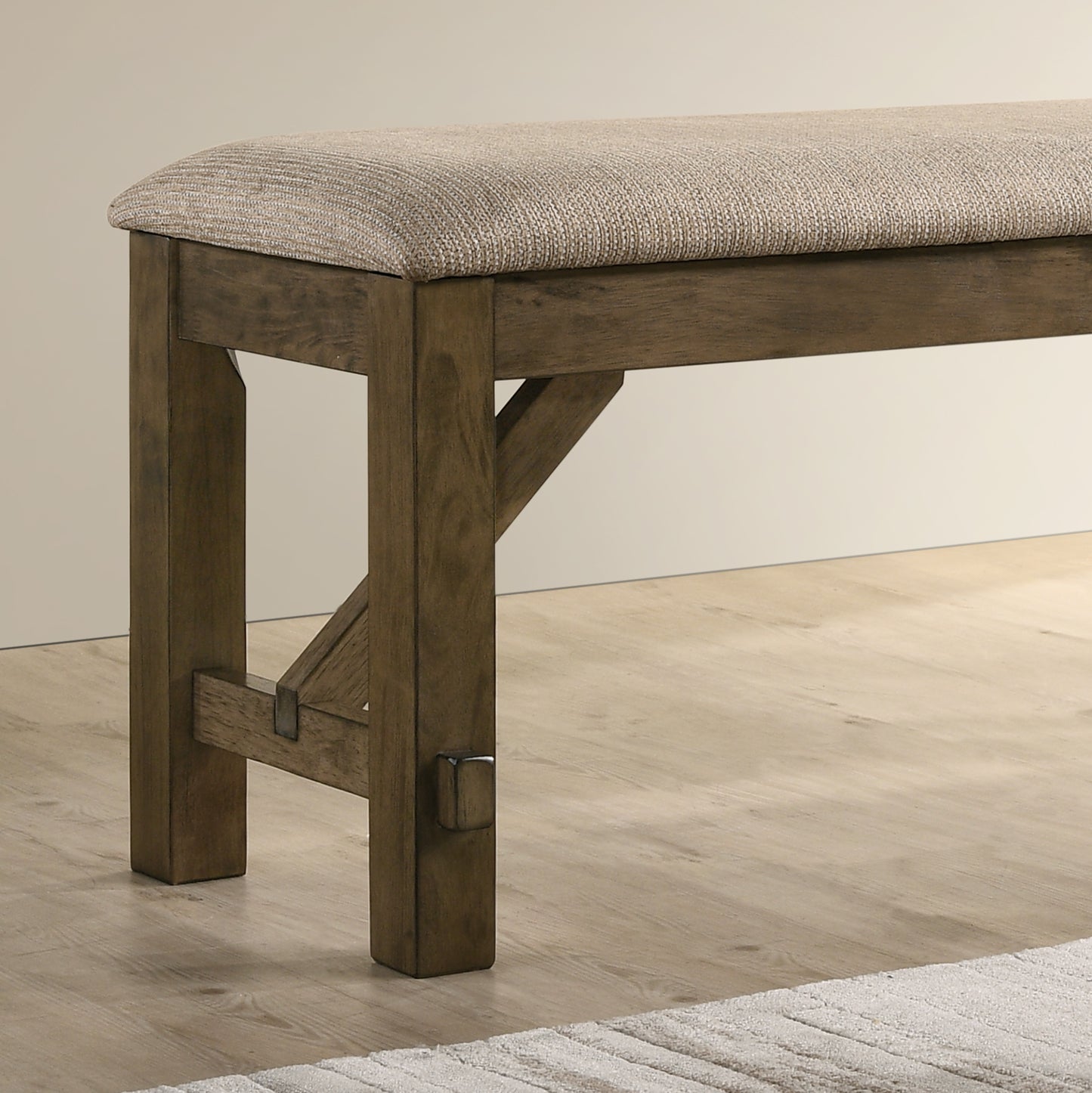 Rustic wood bench with beige textured upholstered seat