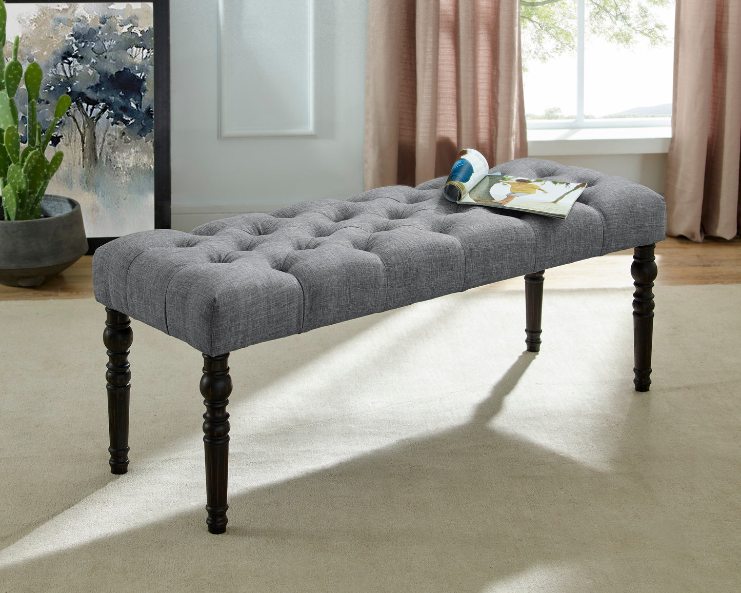 Grey fabric tufted bench with dark wood legs
