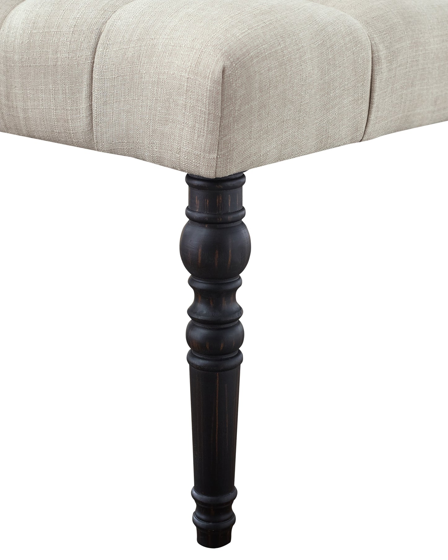 Tufted linen ottoman with dark turned wood legs