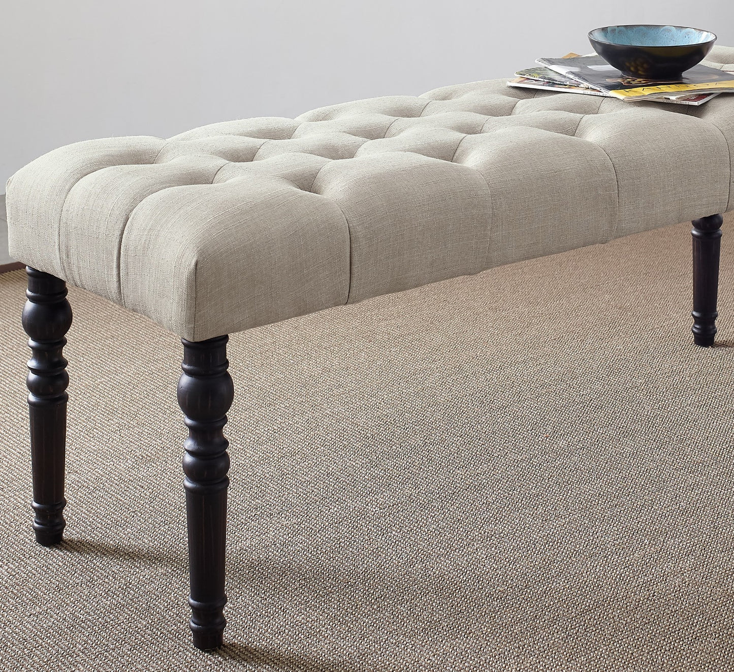 Tufted linen bench in beige with dark wood turned legs perfect for entryway seating