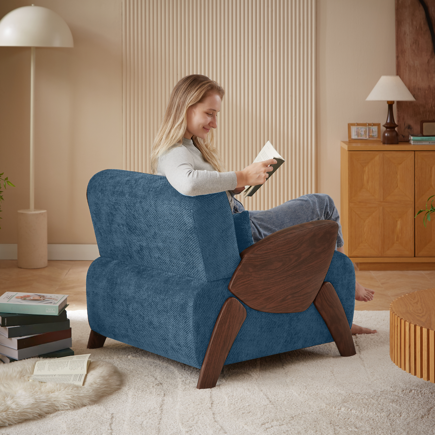 Comfortable blue fabric armchair with midcentury modern wooden accents perfect for reading