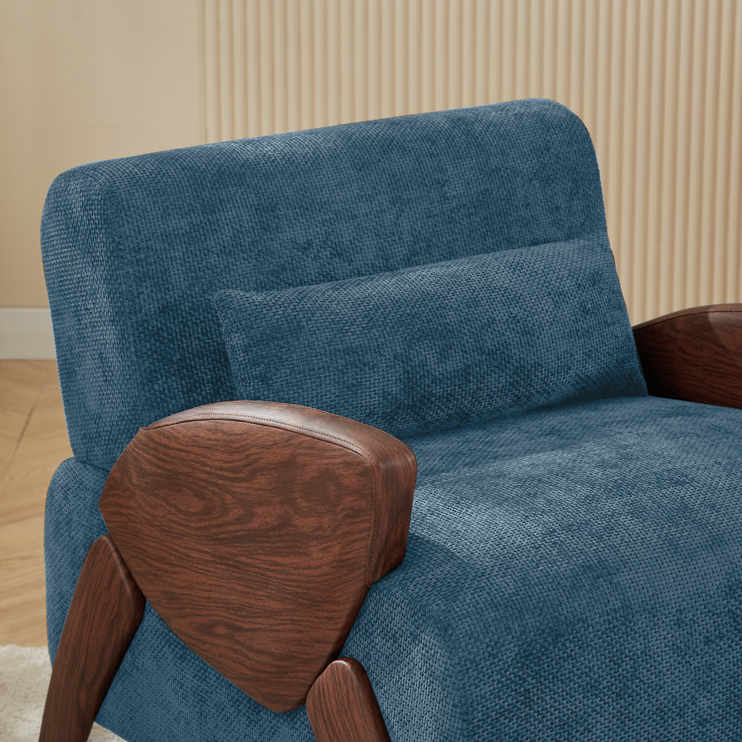 Blue textured fabric armchair with rich wood accents and a lumbar pillow