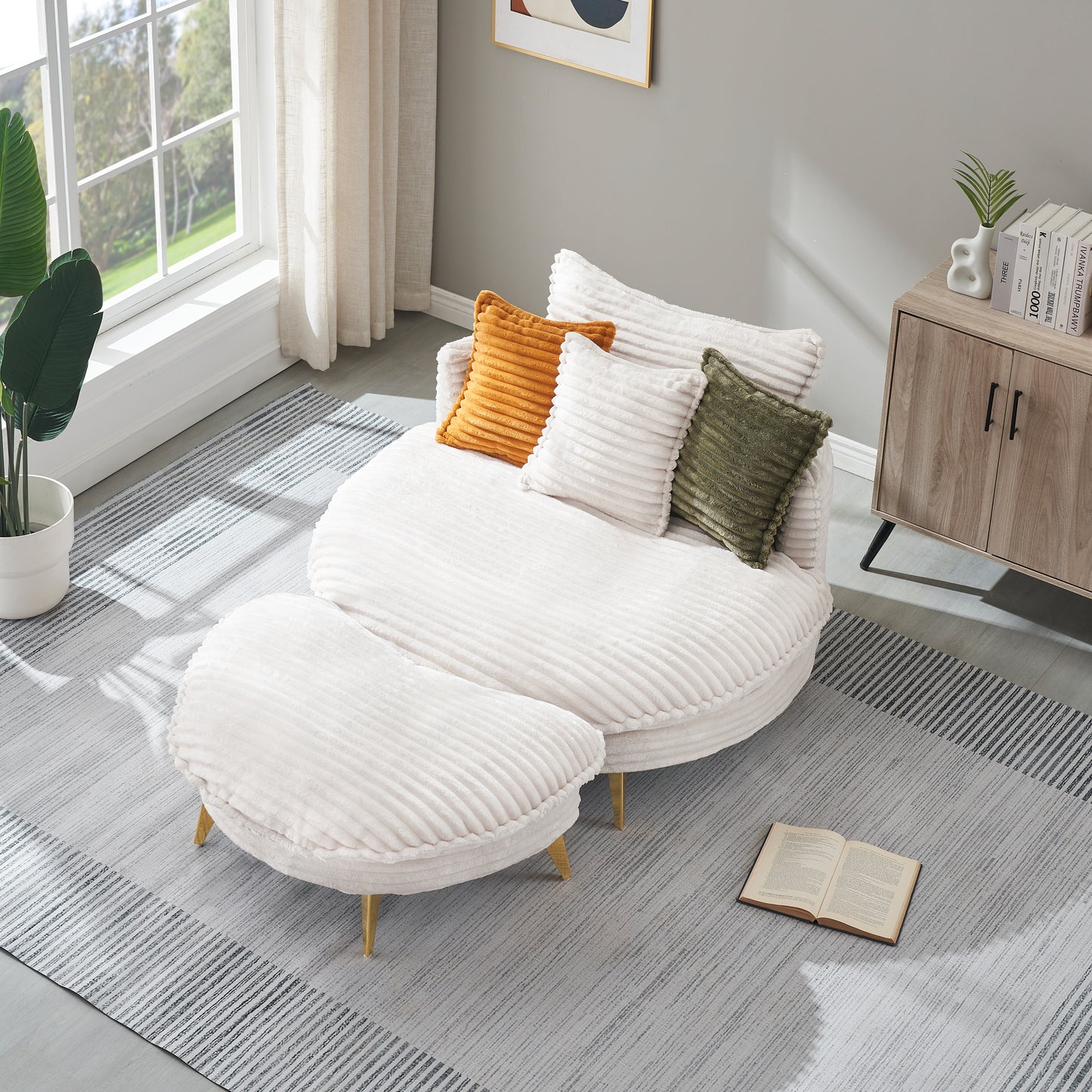 Plush white corduroy sectional sofa with brass legs and colorful accent pillows