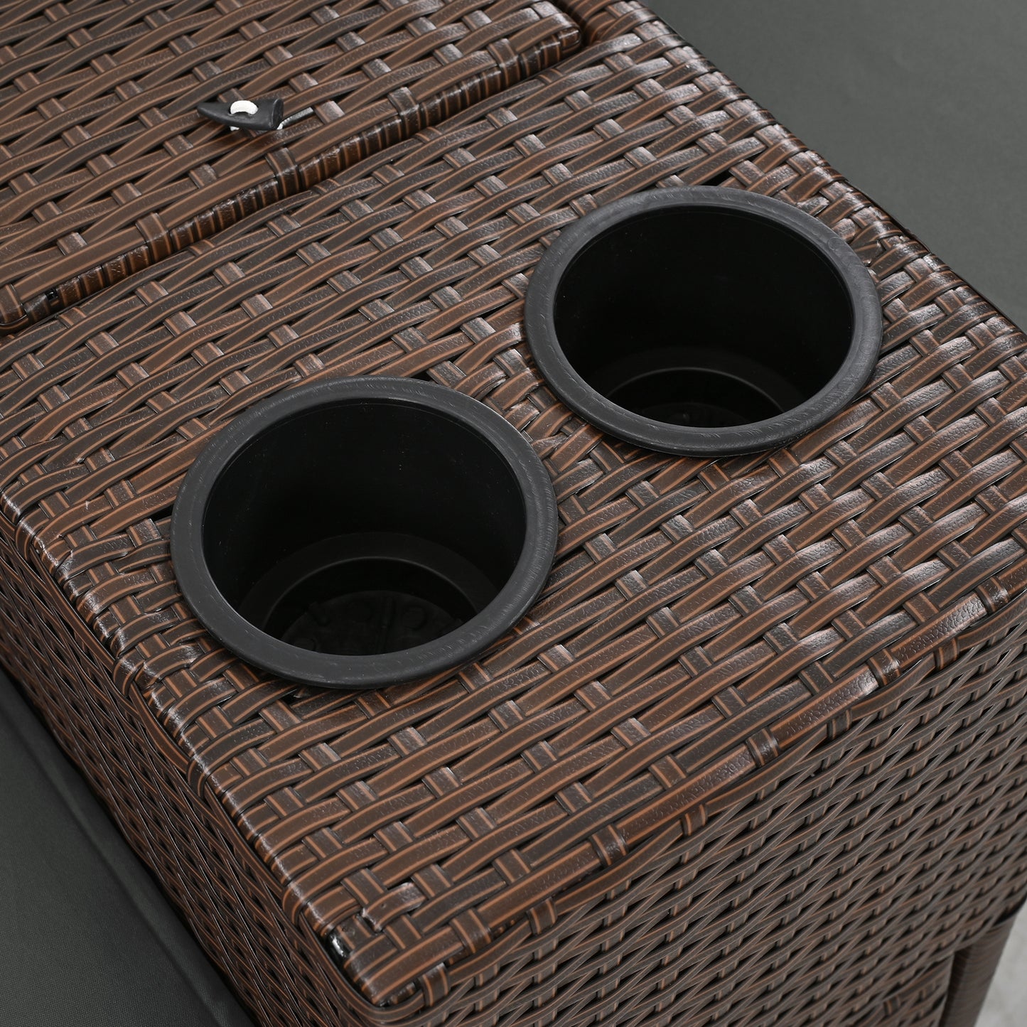 Brown rattan storage ottoman with two black cup holders integrated for outdoor relaxation