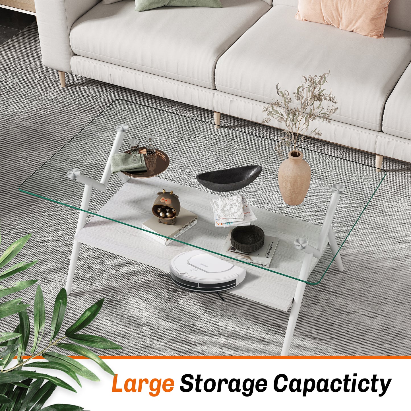 Modern white metal coffee table with clear glass top and wood shelf featuring decorative items
