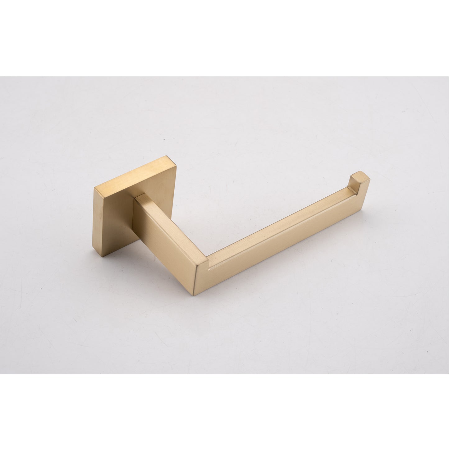 Brushed brass toilet paper holder with a modern square base and sleek arm