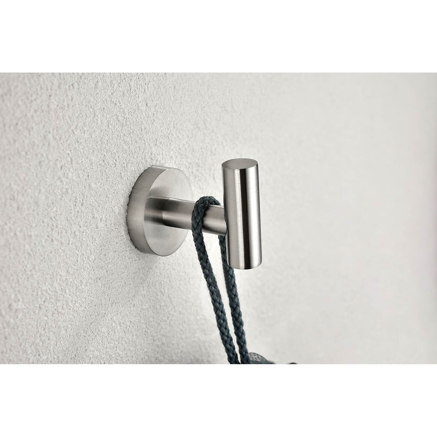 Brushed nickel single robe hook mounted on textured wall holding a dark rope
