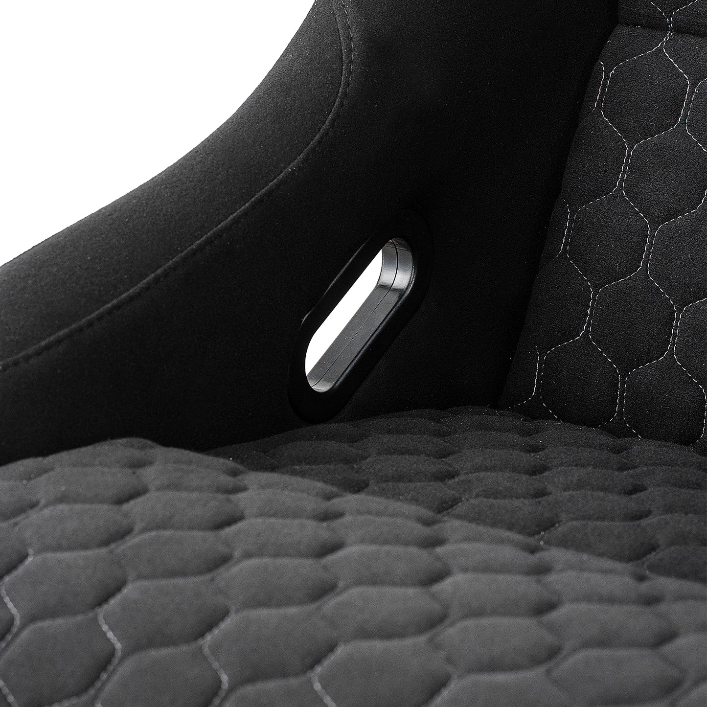 Black racing bucket seat with hexagonal stitching and harness cutout detail