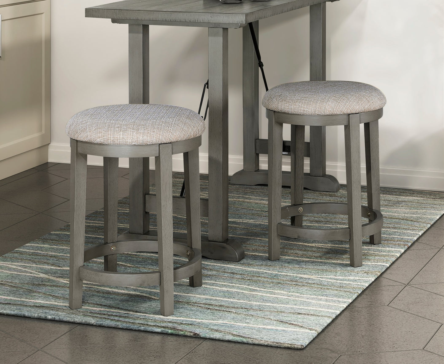 Gray wooden bar stool with textured gray fabric seat perfect for a kitchen island