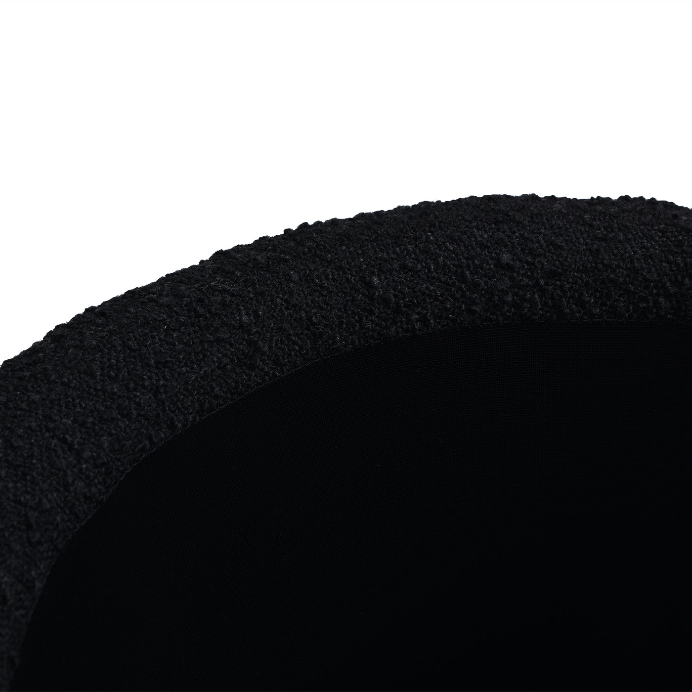 Black textured knit fabric trim on a dark smooth material
