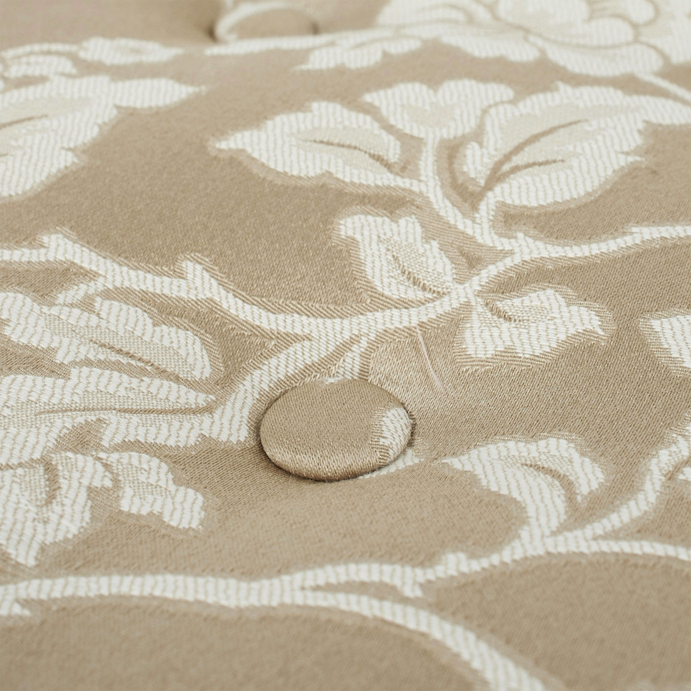 Beige floral damask upholstery fabric with tufted button detail