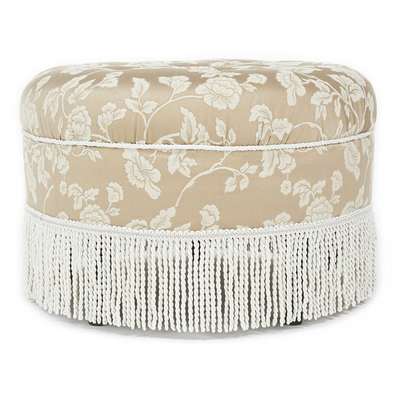 Elegant beige fabric ottoman with a white floral damask pattern and decorative fringe