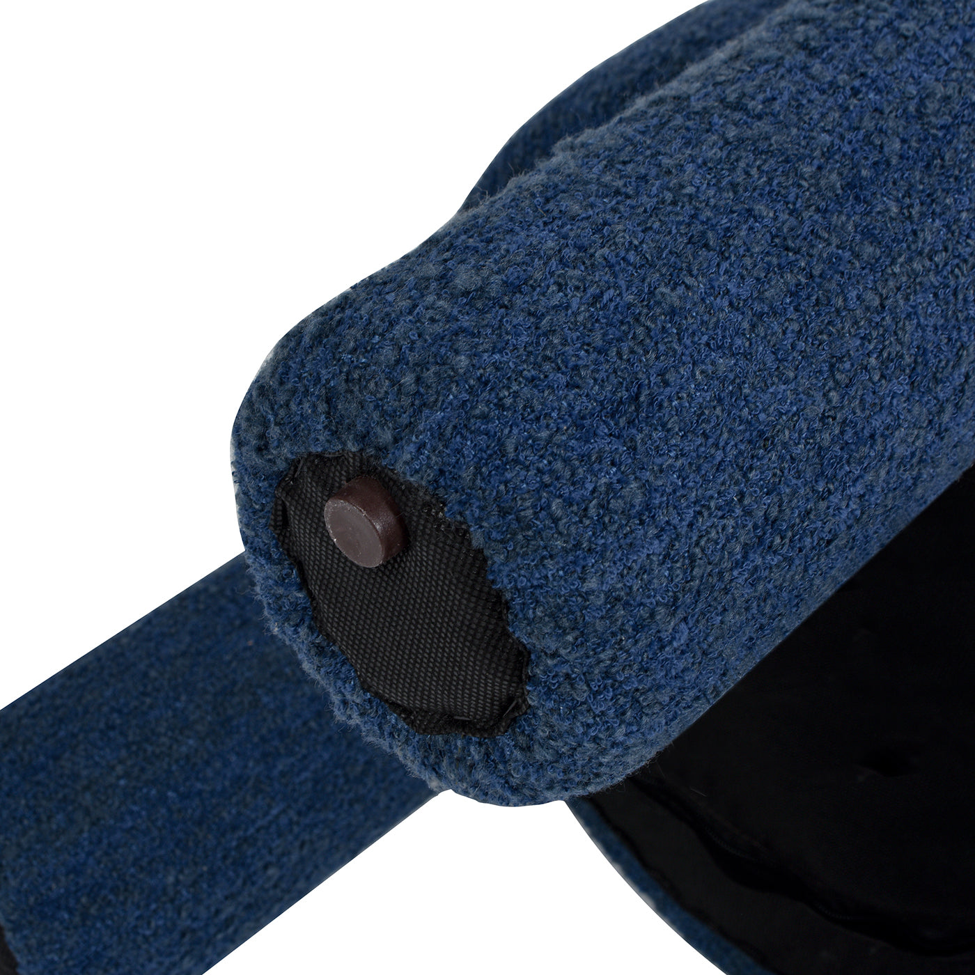 Closeup of a textured blue fabric roller with a visible brown stud attachment