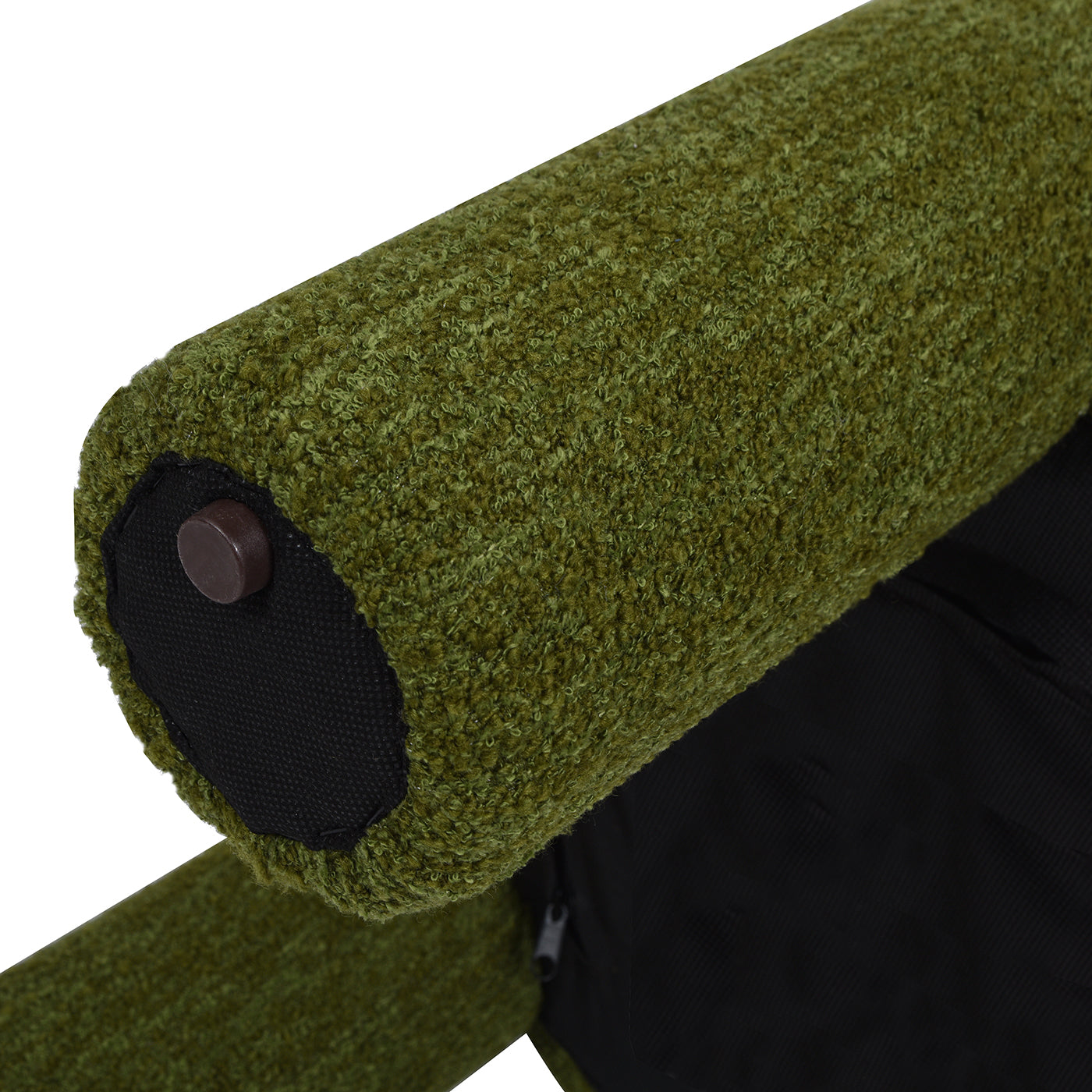 Closeup of textured moss green boucle fabric on a chair armrest showing its plush weave
