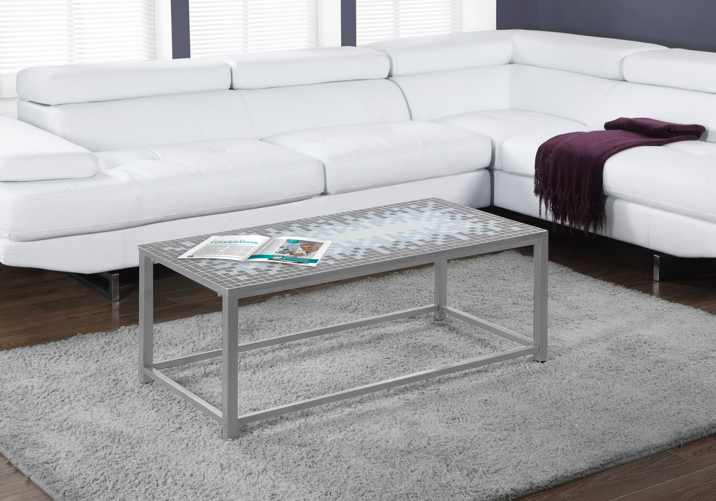 White leather sectional sofa with a plum throw blanket draped over the armrest