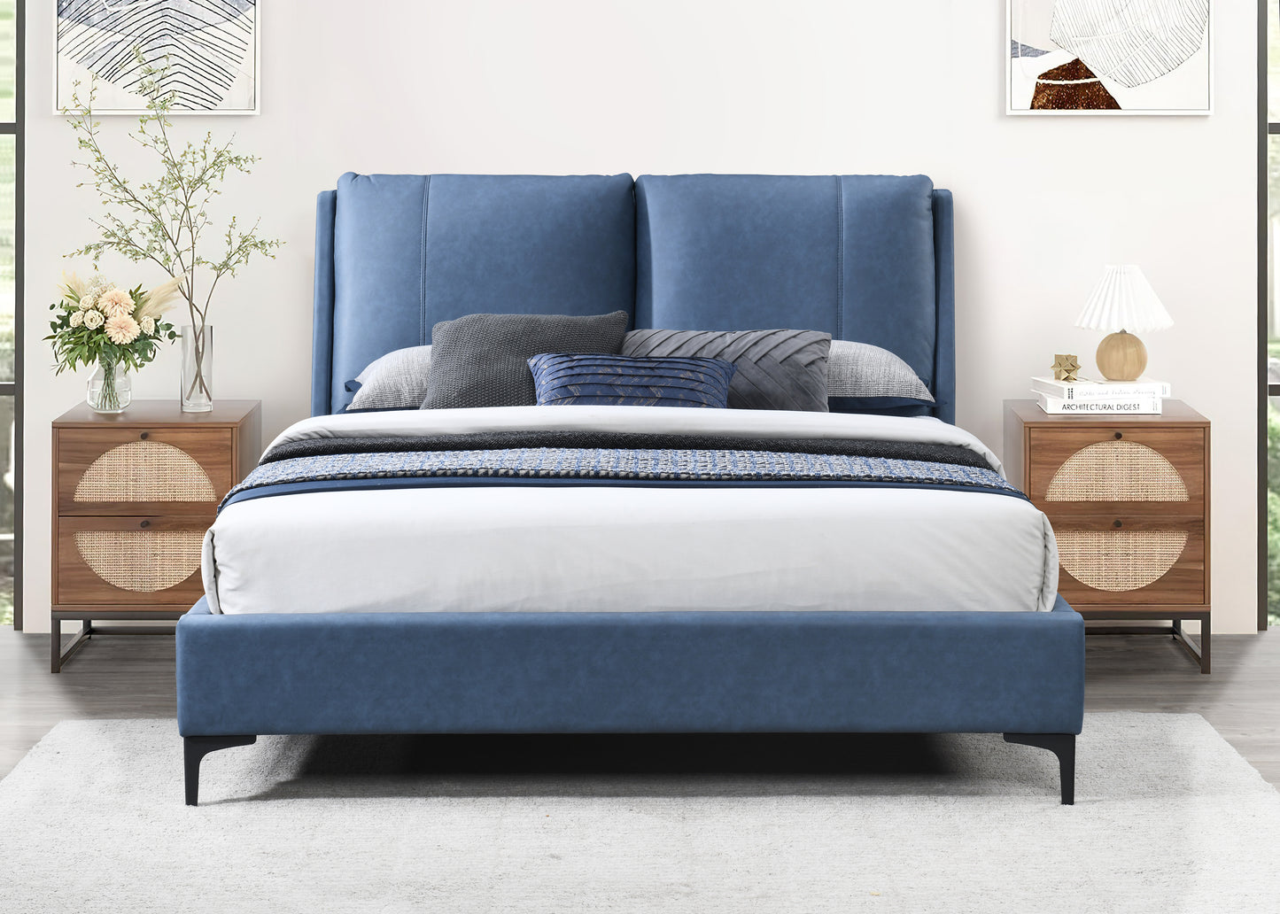 Blue upholstered king bed with woven nightstands and abstract art