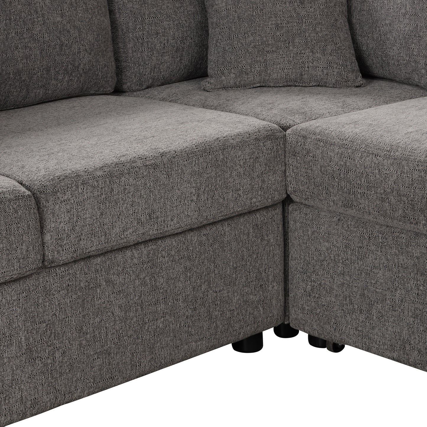 Closeup view of a textured charcoal grey fabric sofa section highlighting plush cushions and modern design