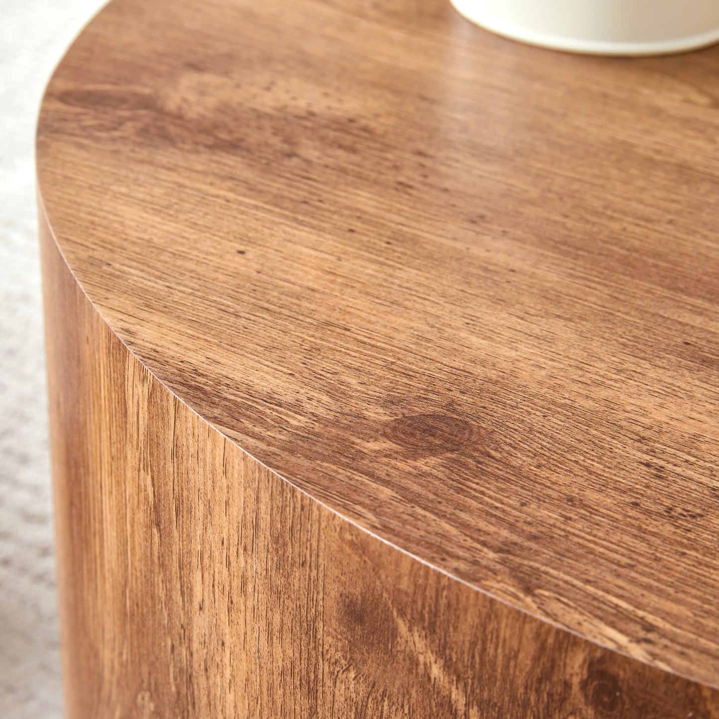 Closeup of a round wooden coffee table with a natural wood grain finish ideal for modern living rooms