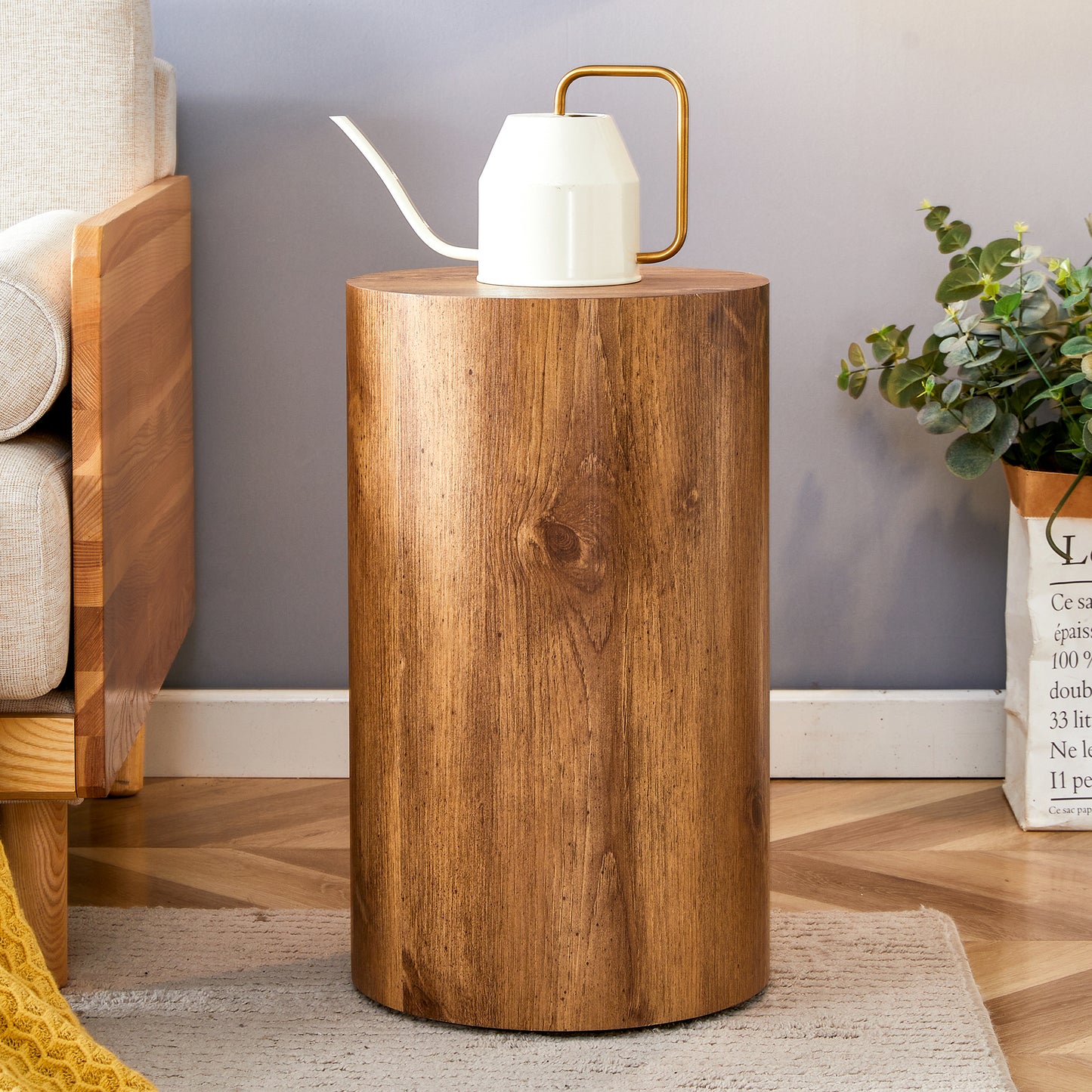 Natural wood round side table with modern gold watering can