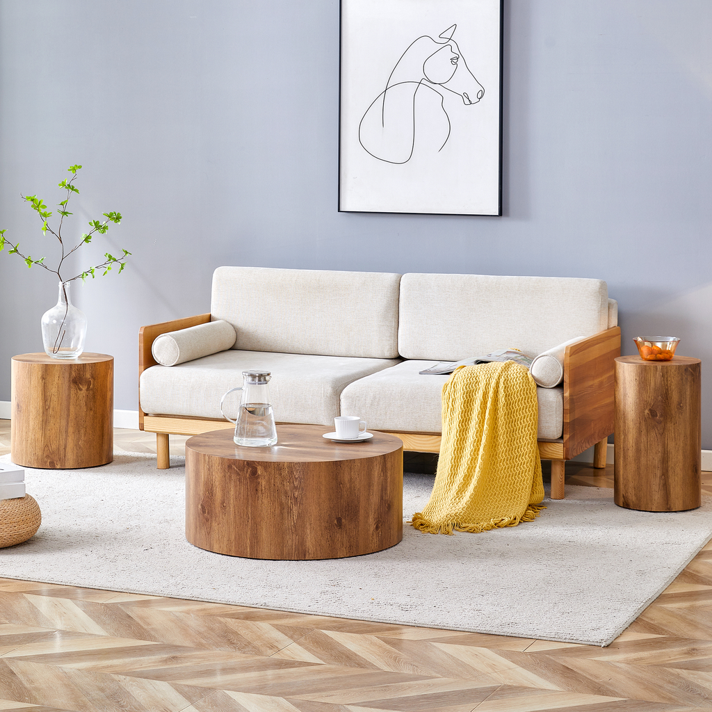 Round wooden coffee table with rich grain holding a glass pitcher and teacup for modern living rooms