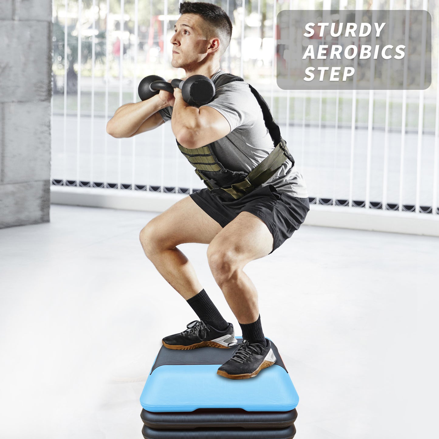 Man performing a squat on a sturdy aerobics step holding a dumbbell for weight training